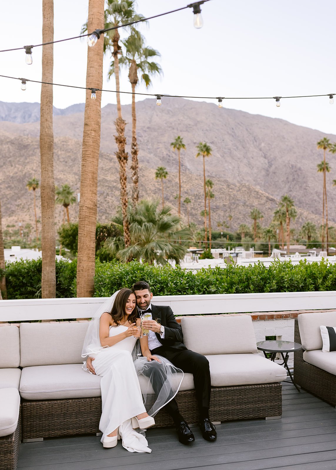 Bride and groom share a cheers during a private moment.