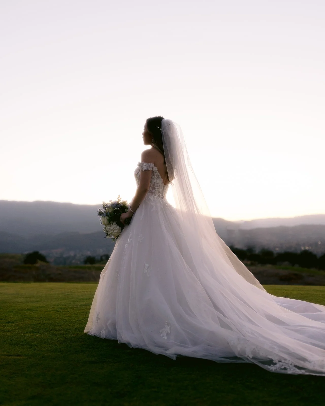 Bride poses on the golf course at this country club wedding.