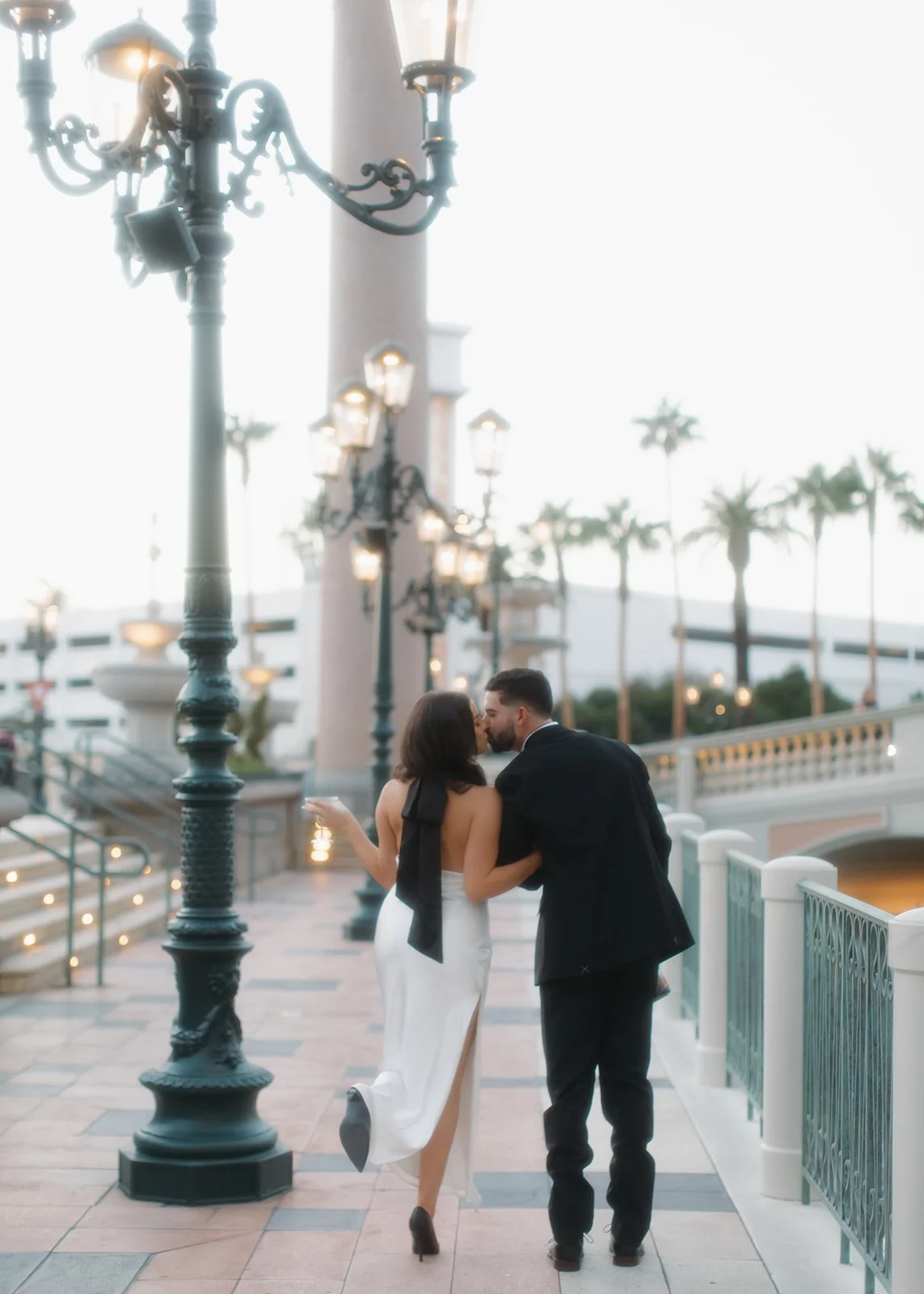 Outdoor kiss captured during sunset engagement portrait.