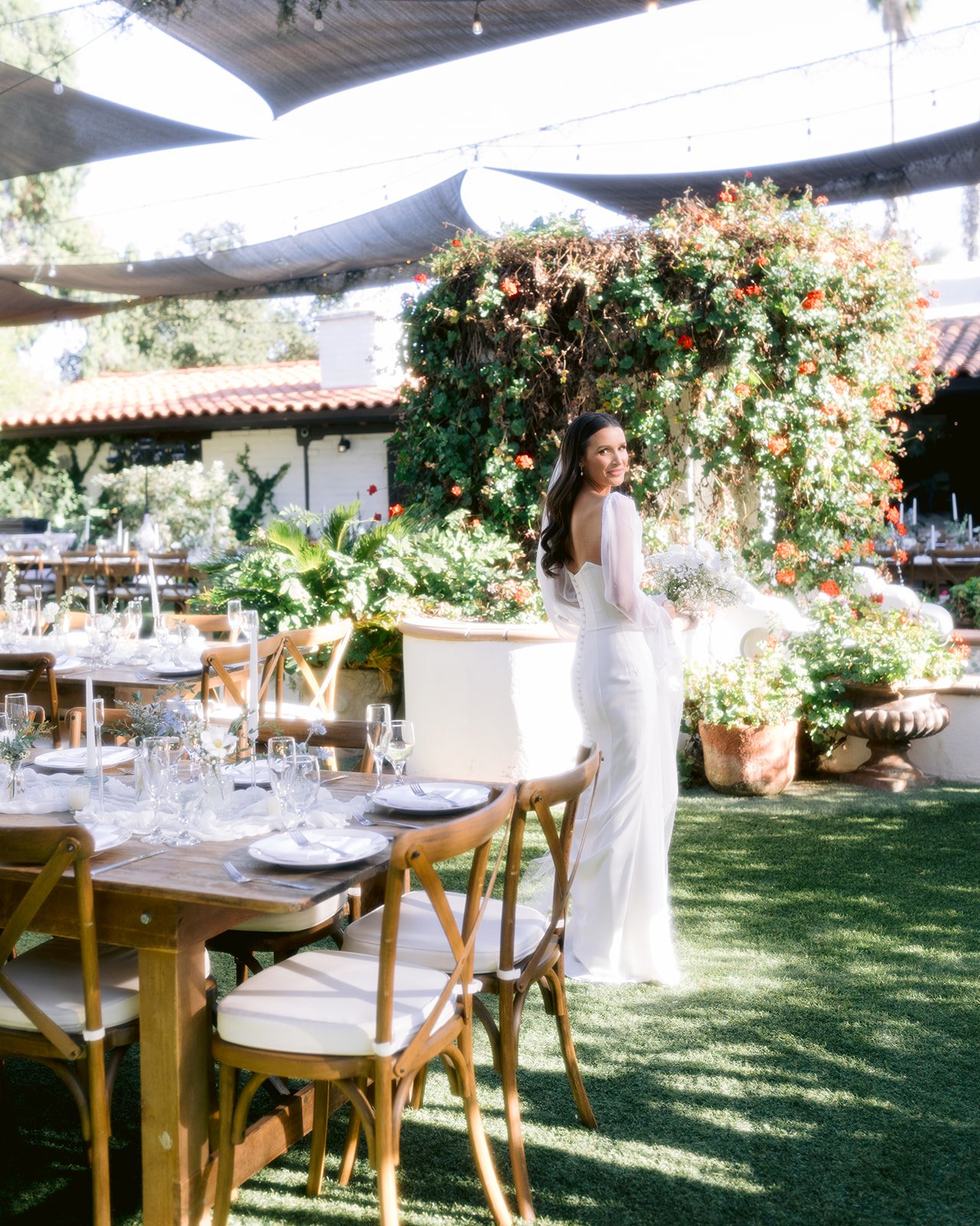 Bride styled within reception space during composed wedding portrait.