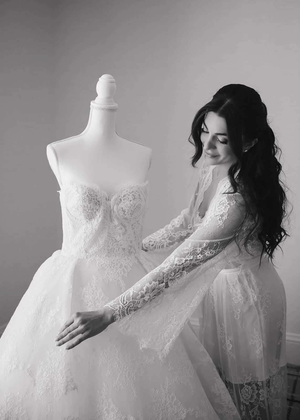 Bride looking at her wedding dress before she gets dressed.