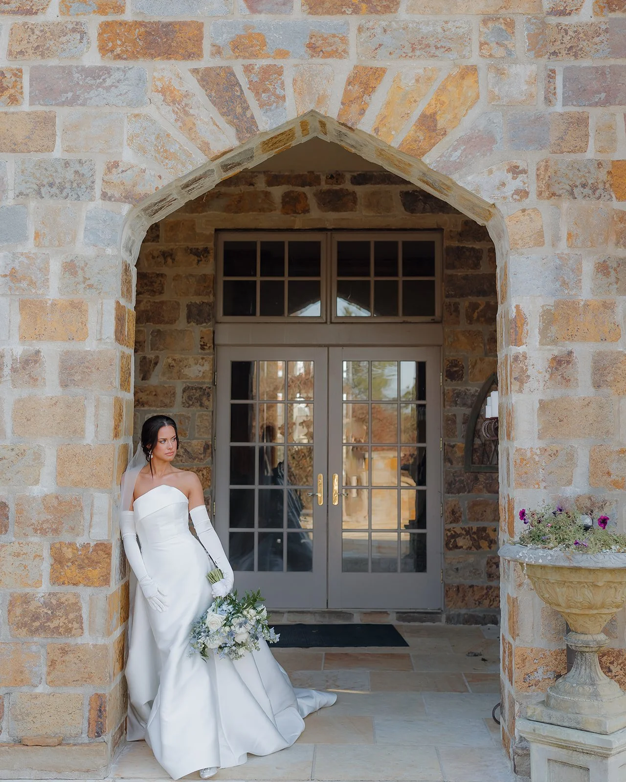 Bride poses for portrait at estate venue similar to Jacksonville wedding venue.
