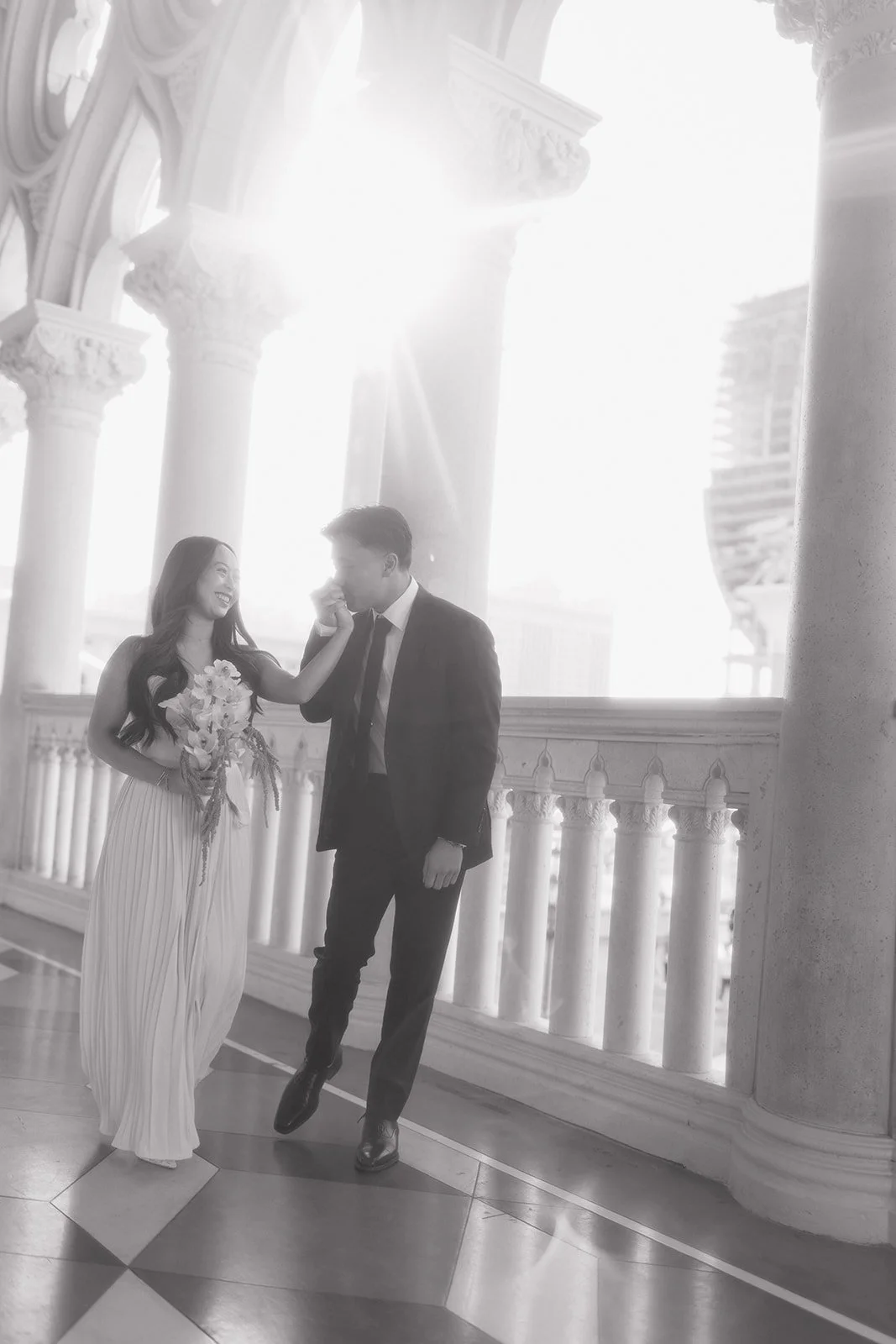 Editorial engagement portrait framed by grand architectural details.