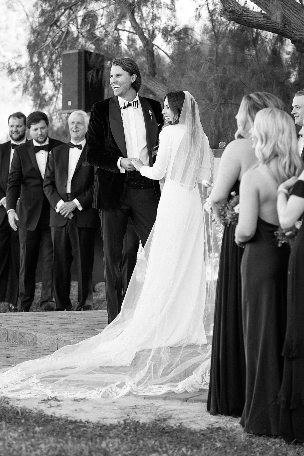 Couple shares a laugh amongst their guests at this black tie affair.