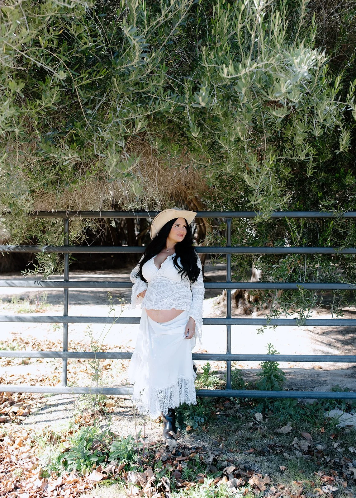 Mom to be posing at her maternity photoshoot.