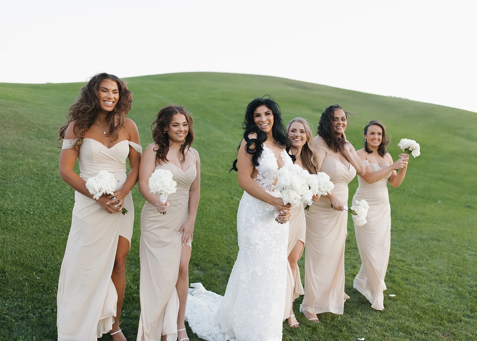 Bridesmaids walking together during outdoor wedding portrait session.