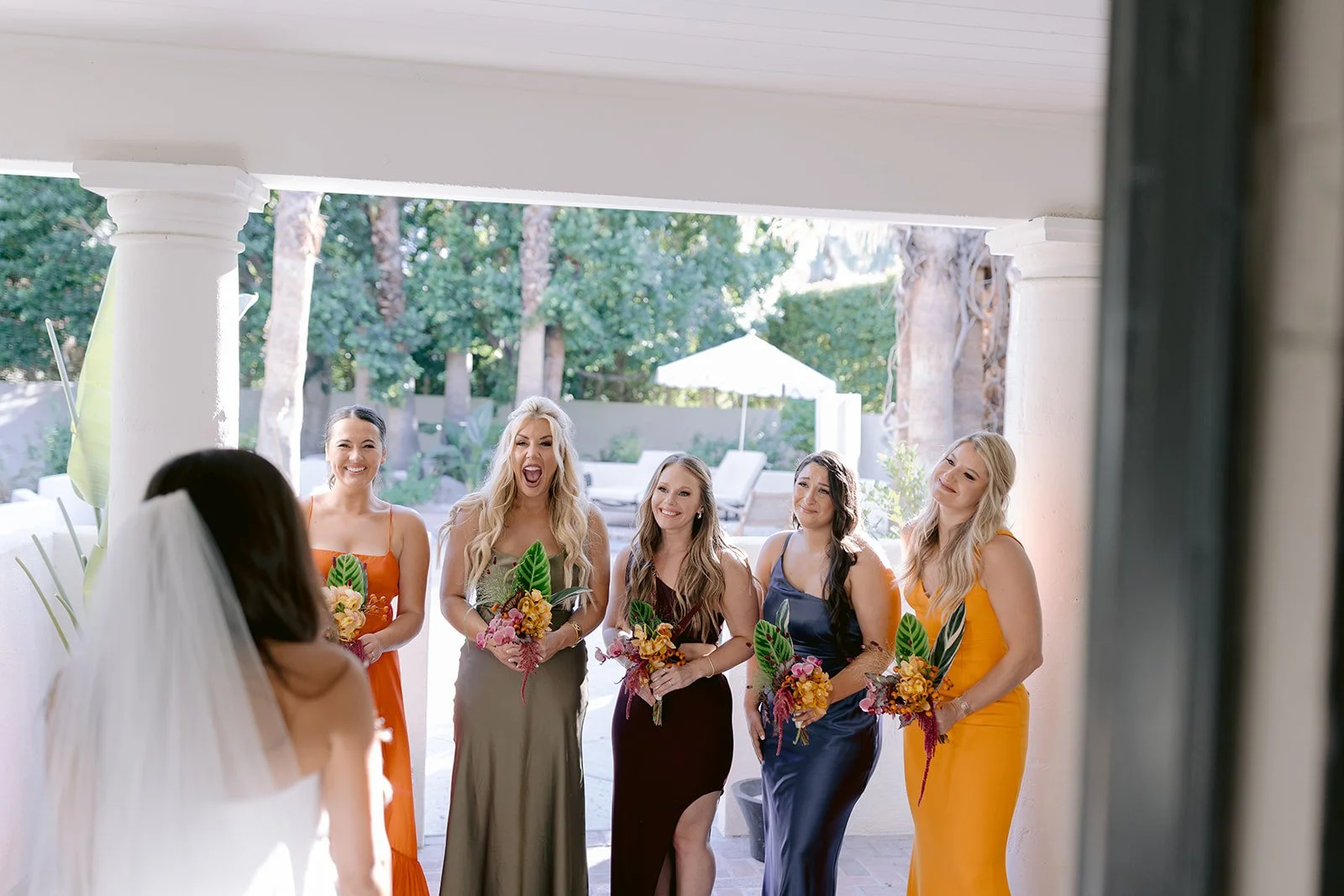 Bridesmaids react to seeing bride for the first time.