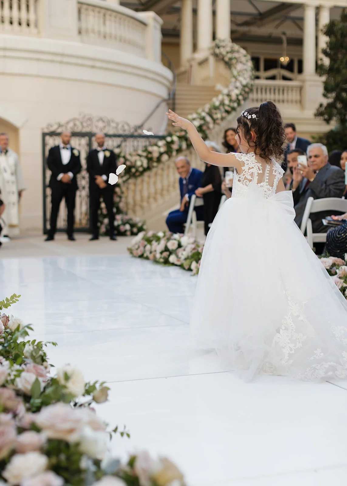 Flower girl throwing petals down the aisle.