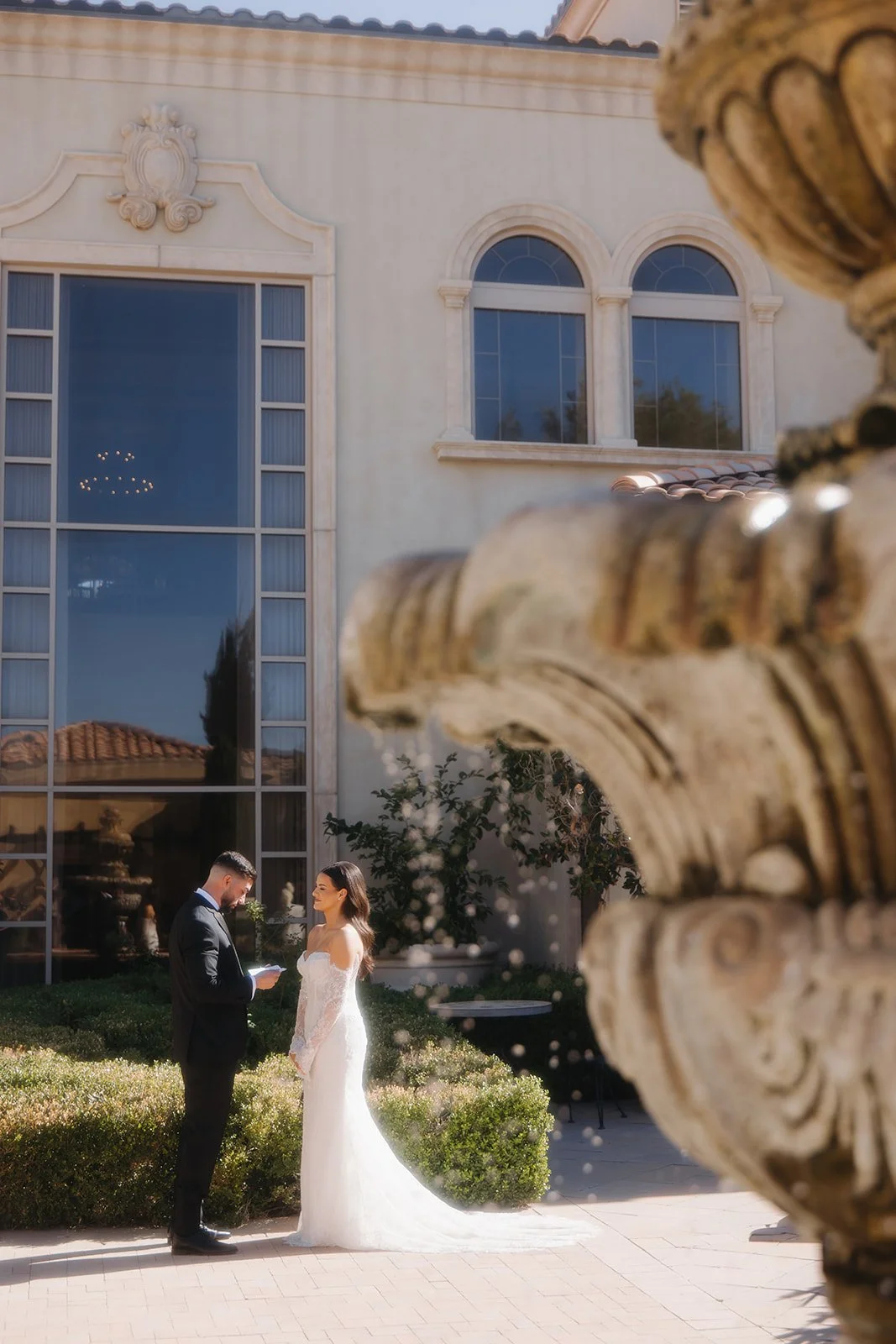 Groom reading vows to bride after their first look.