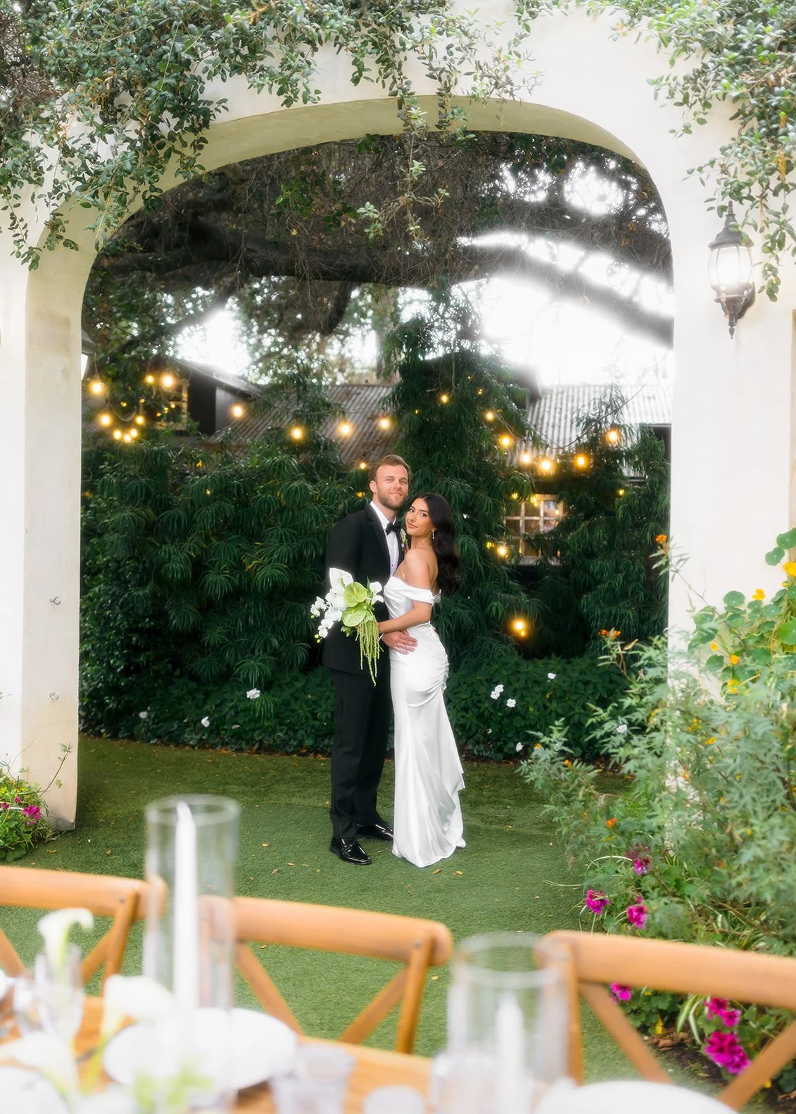 Bride and groom centered within open space.