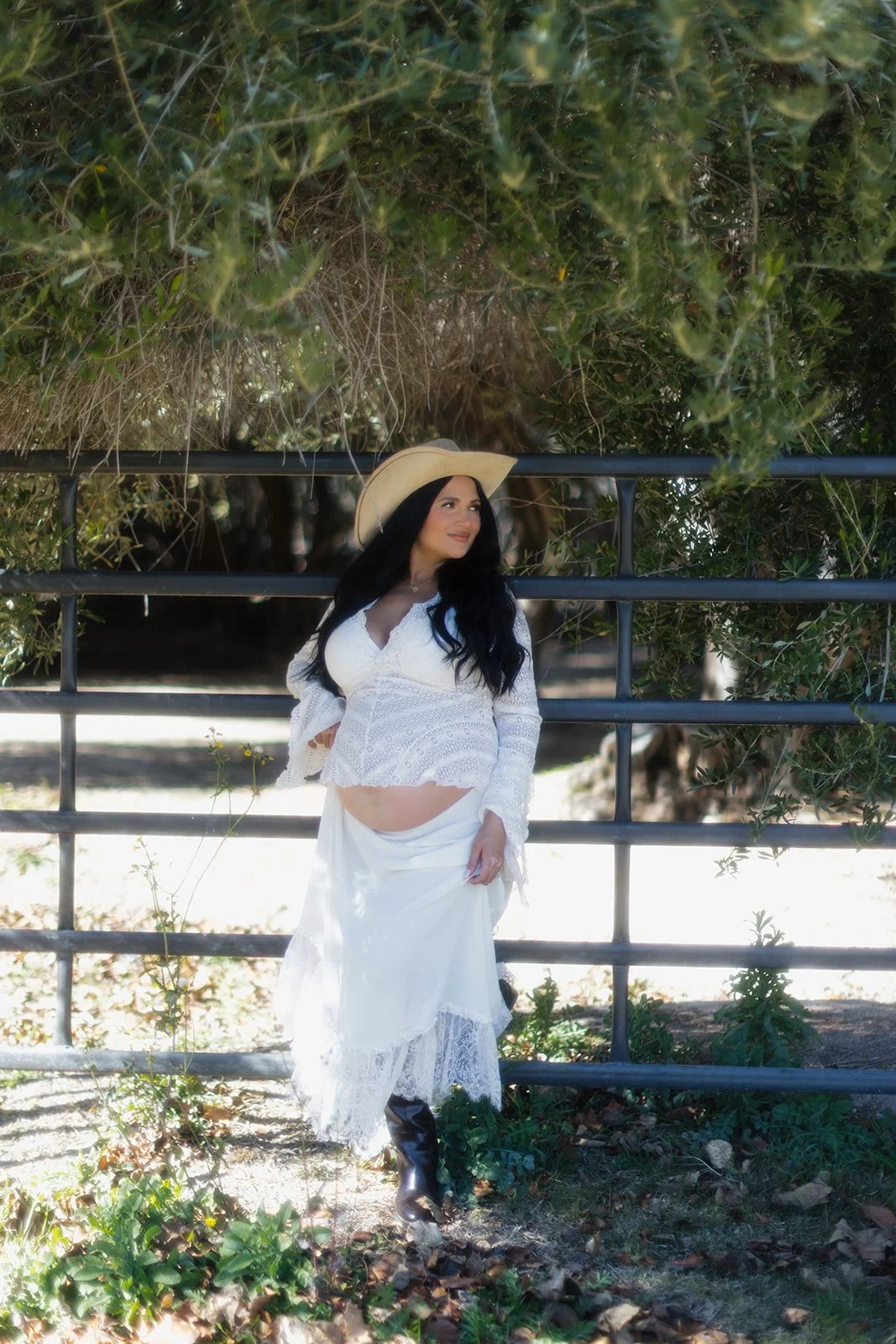 Maternity portrait captured in soft evening light with composed styling.