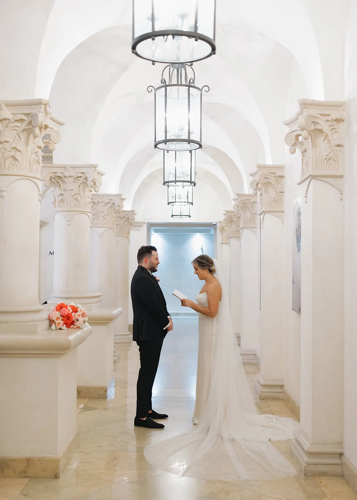 Bride and groom share vows in an elegant, historic wedding venue.