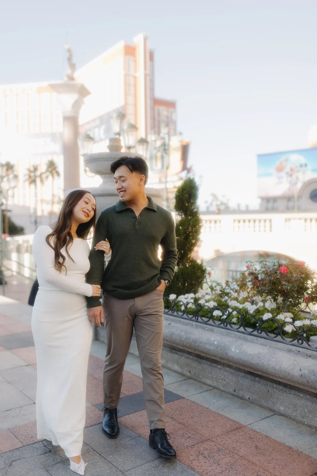 Bride and groom laughing during engagement photos.