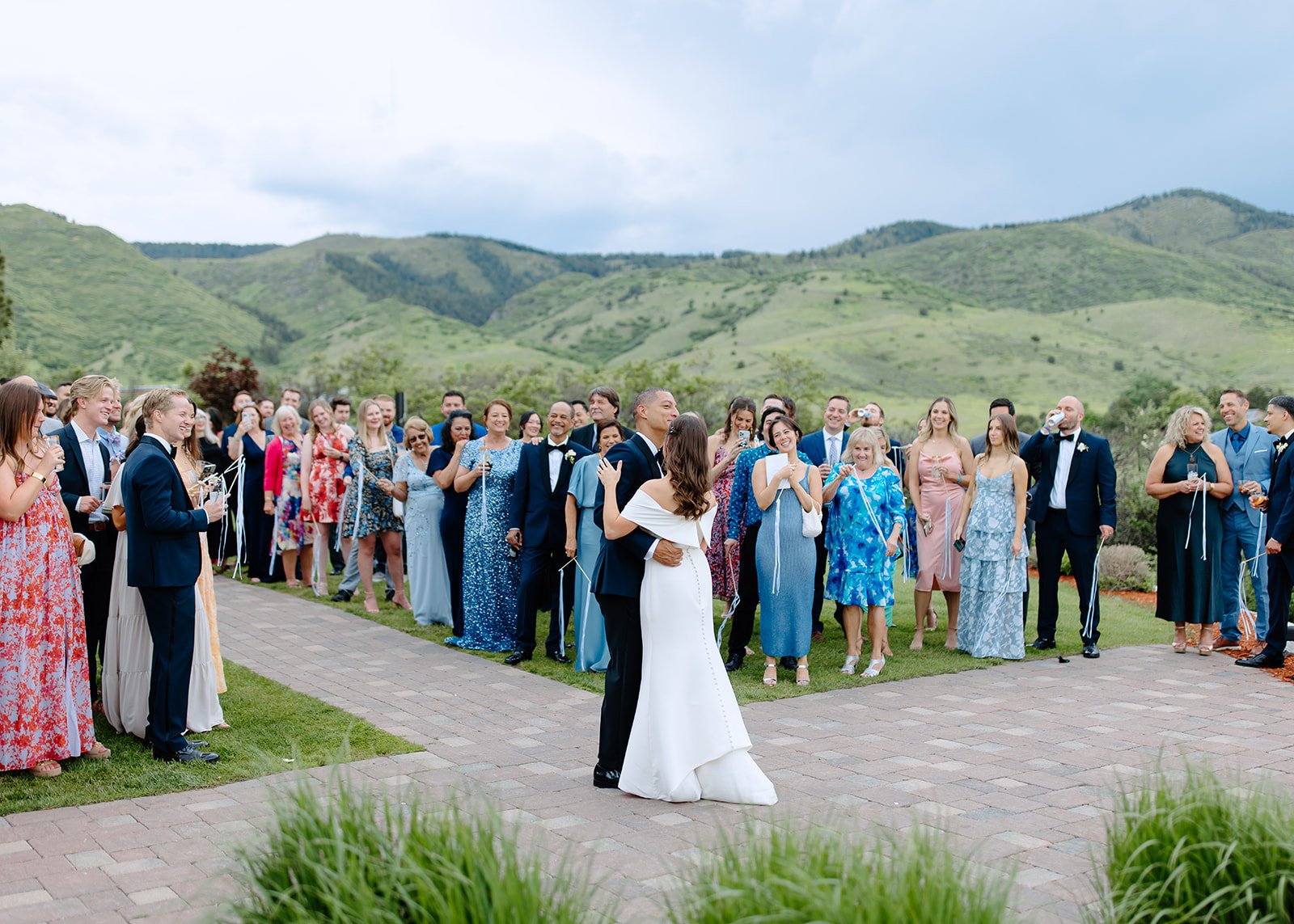 Bride and groom share their first dance outdoors.