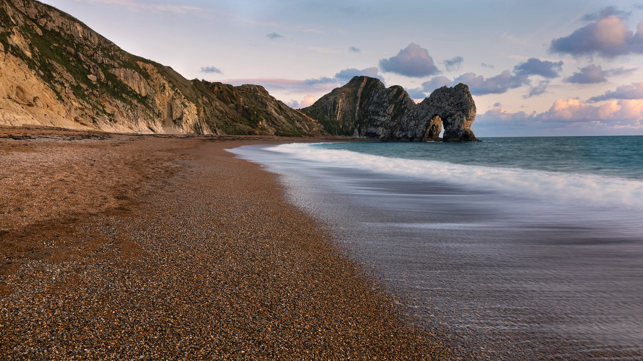 Durdle Door , Jurassic coast long exposure sunset landscape image.