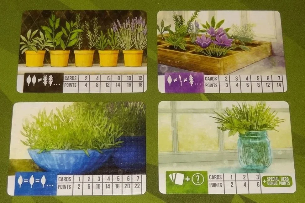 Four plant-themed cards with illustrations of potted plants and corresponding point values, arranged on a green surface.