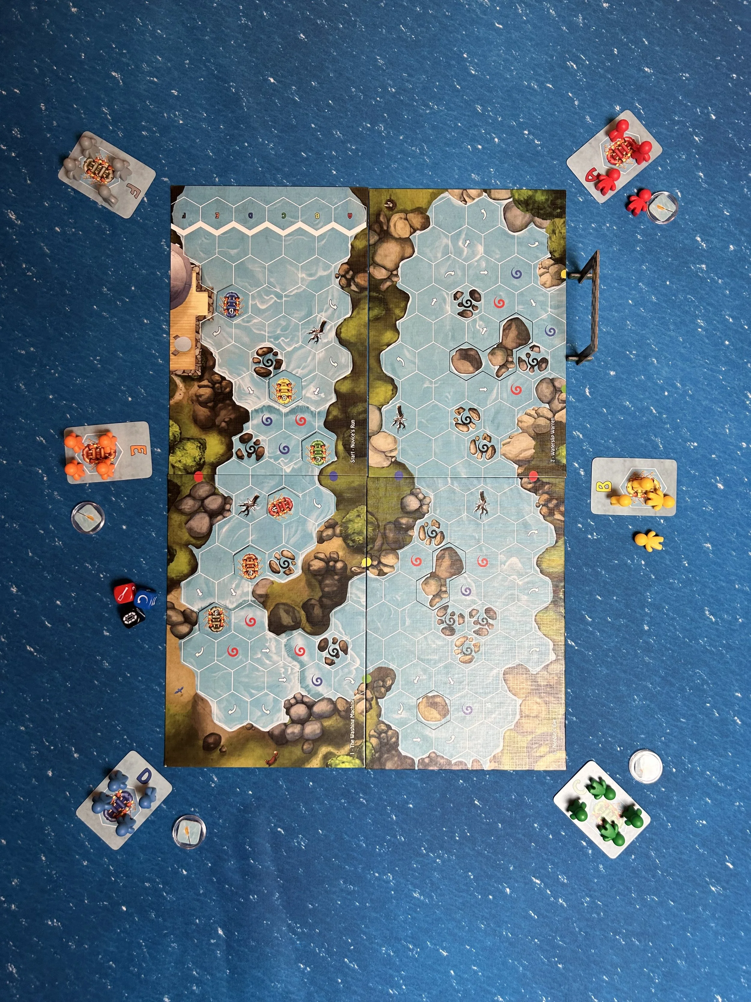 A game of Vikings chess played on a hexagonal grid with miniature Viking figures, dice, and player pieces in different colors around the board.