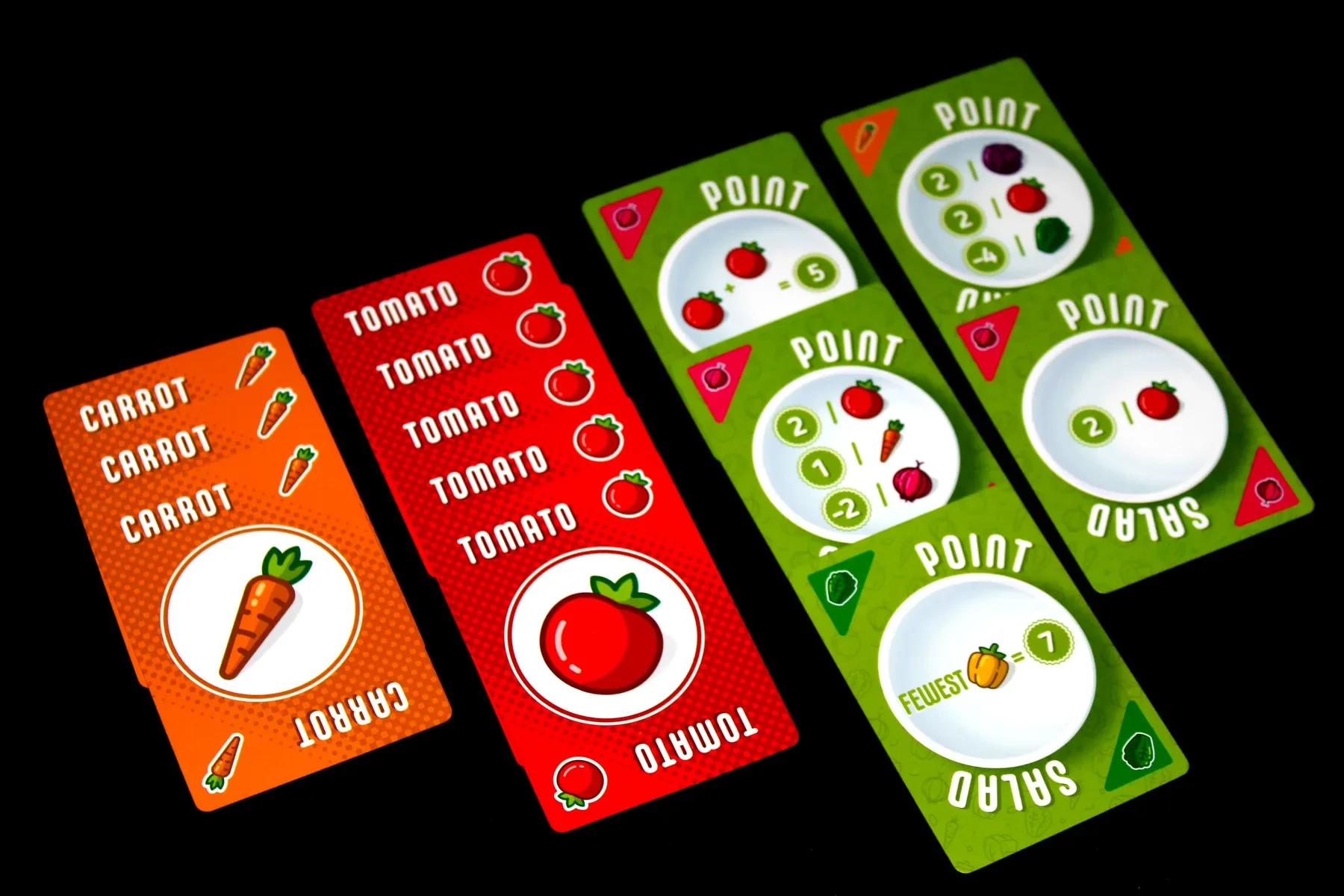 Set of colorful game cards with vegetables like carrot, tomato, and pumpkin, featuring point values and icons.