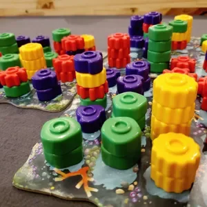 Colorful interlocking building blocks on a foam base for a children's game or activity.