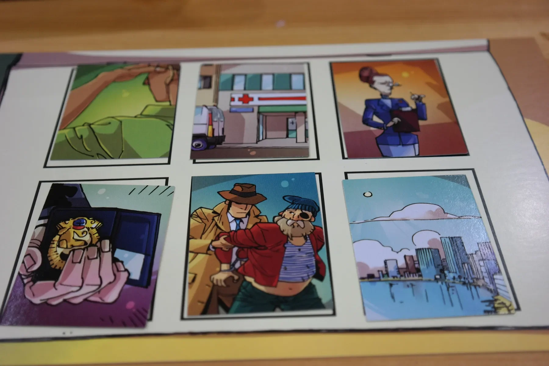 A sheet with six cartoon-style images in a 2x3 grid. Top row: a hand reaching for a pair of glasses, an ambulance outside a hospital, a woman smoking a cigarette. Bottom row: a lion with glasses on a phone, a man in a trench coat and hat talking to a bearded man with a red jacket, a city skyline with buildings by a river.