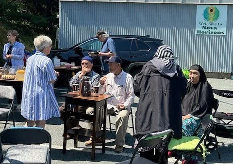 Volunteers enjoy coffee and snacks outdoors in the sun at Nova Horizons.
