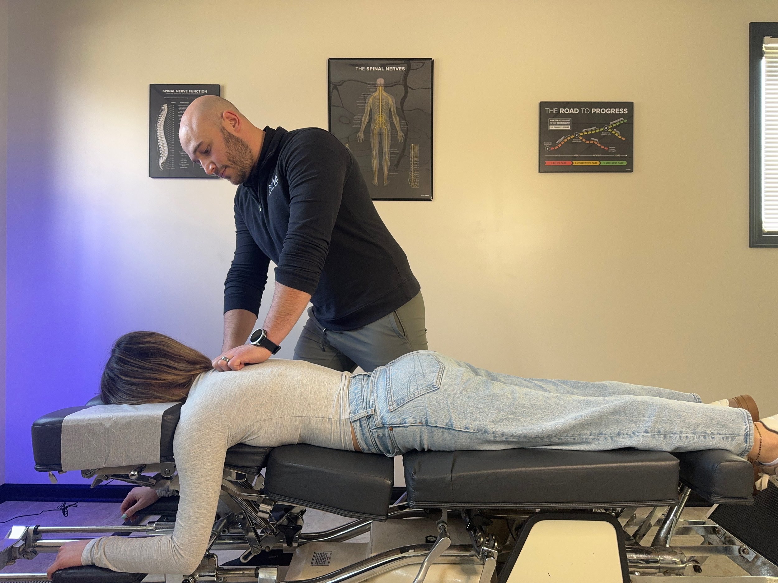 Dr. Jacob Brandman evaluating a patient at Prime Chiropractic Center in Toledo, Ohio