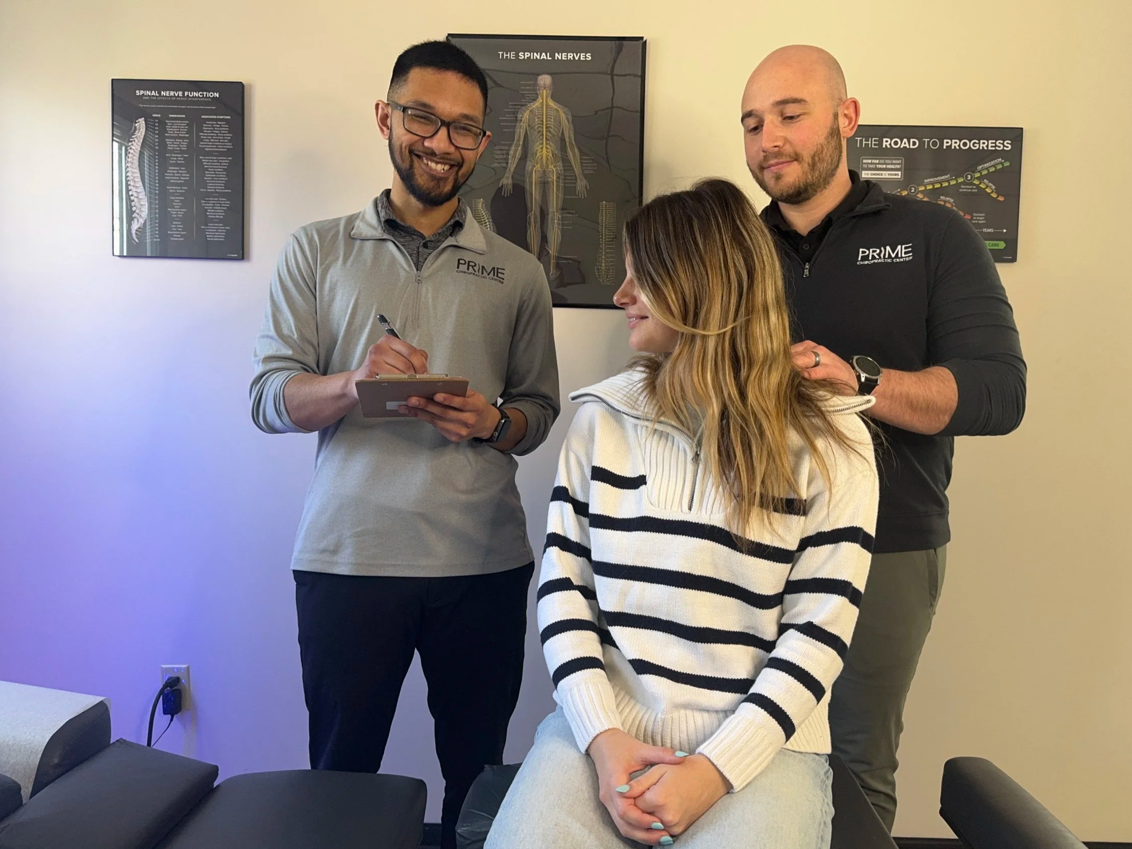 Dr. Ryan de Rosales and Dr. Jacob Brandman performing a patient evaluation at Prime Chiropractic Center in Toledo, Ohio