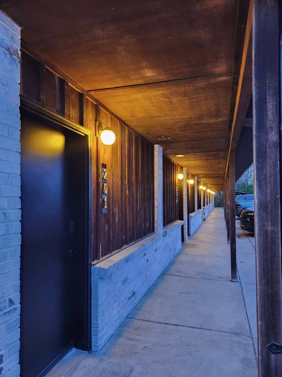 Dusk- view shows our newly lime washed brick, painted doors and new door numbers.