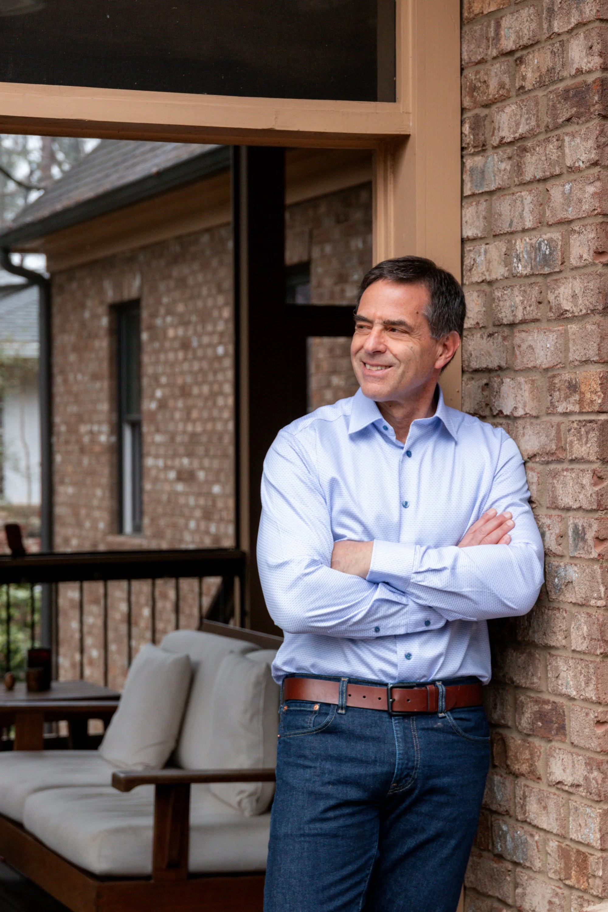 Kevin Abel leaning against a brick wall