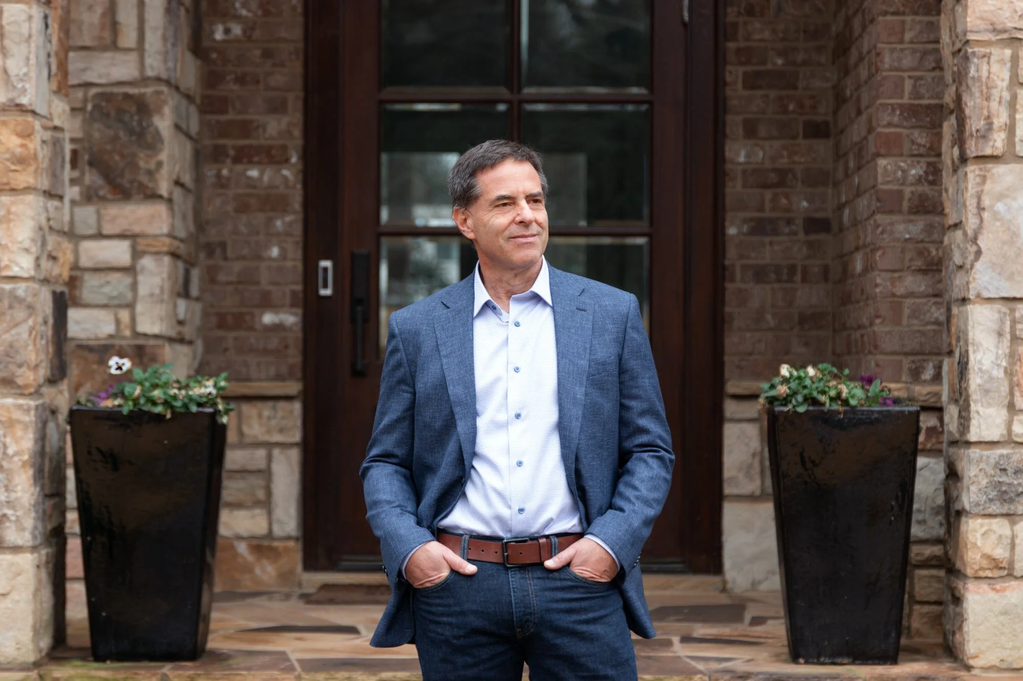 Kevin Abel standing in front of brick house