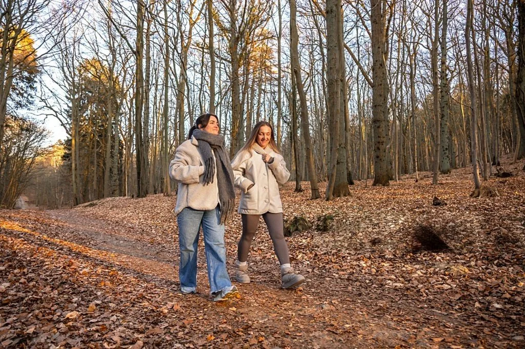 Two women walking together on a nature trail