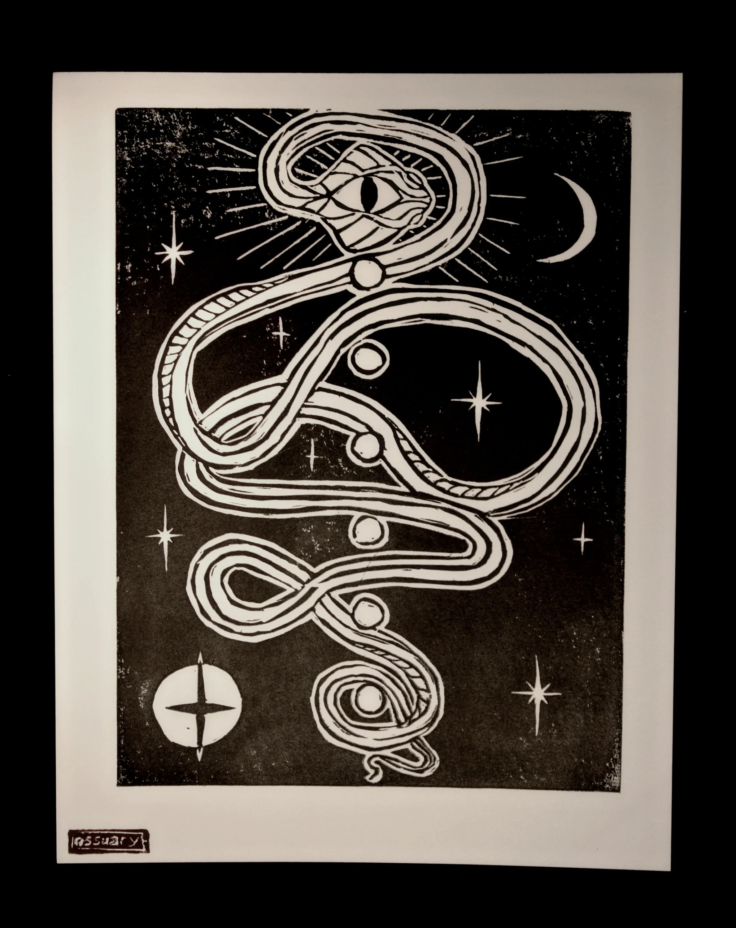 A black and white illustration of a snake intertwined with celestial symbols like stars, a crescent moon, and a compass, with an eye at the top and the artist's signature in the bottom left corner.