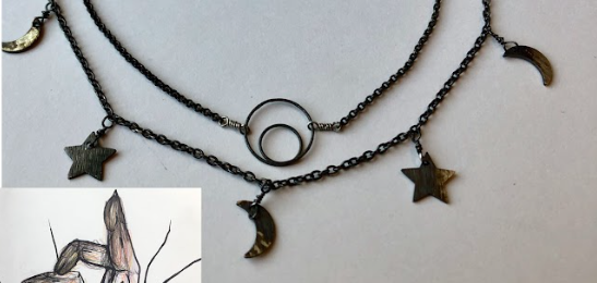Three layered necklaces with star and moon pendants, black beads, and metal rings, laid out flat.