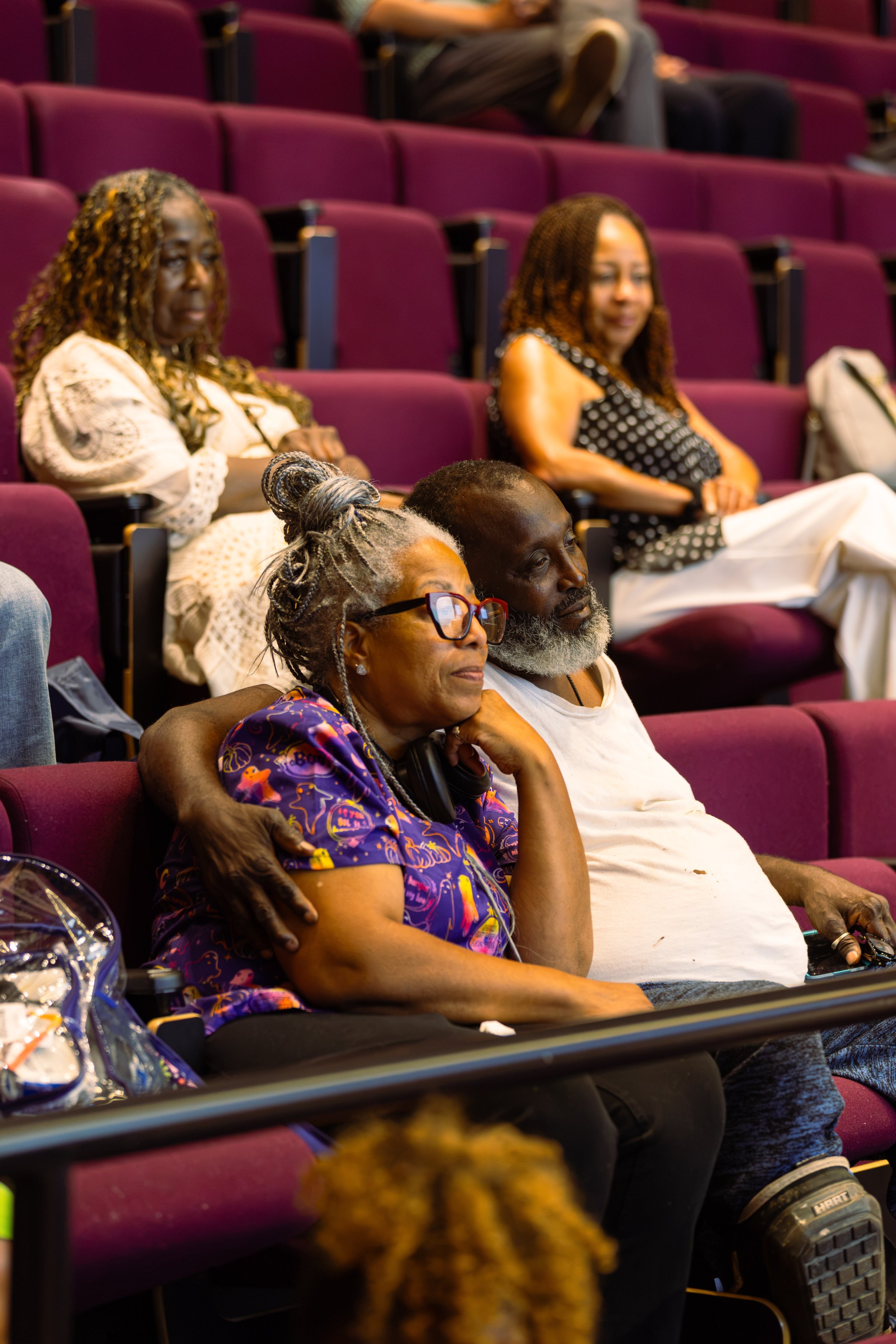 Couple from the community sitting in the audience