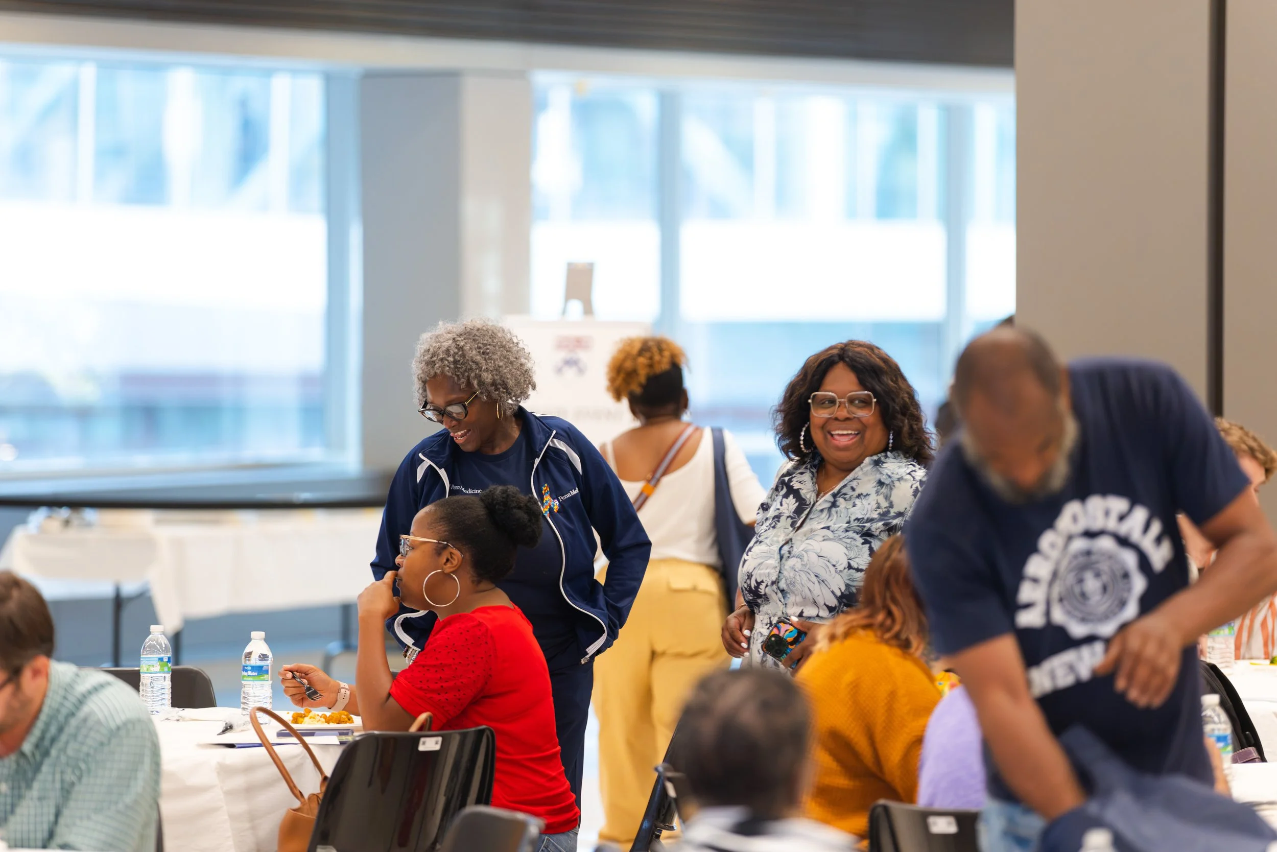 CHJ and community members socializing over their meal