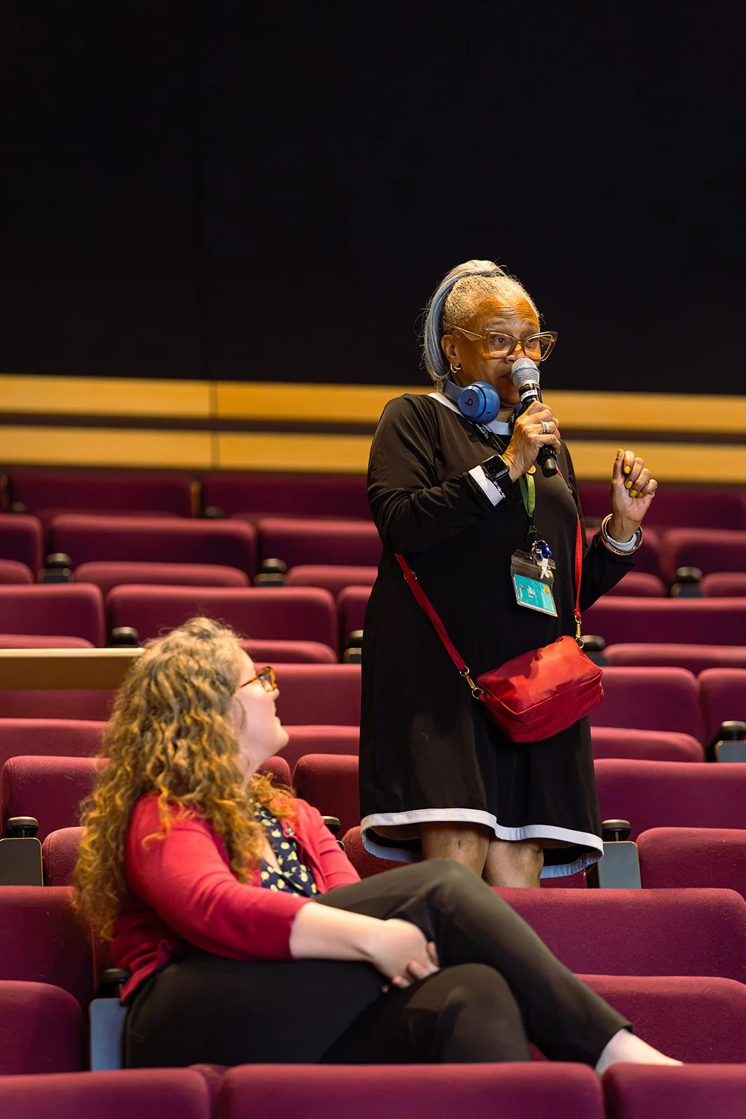 Community member in the audience speaking into a microphone