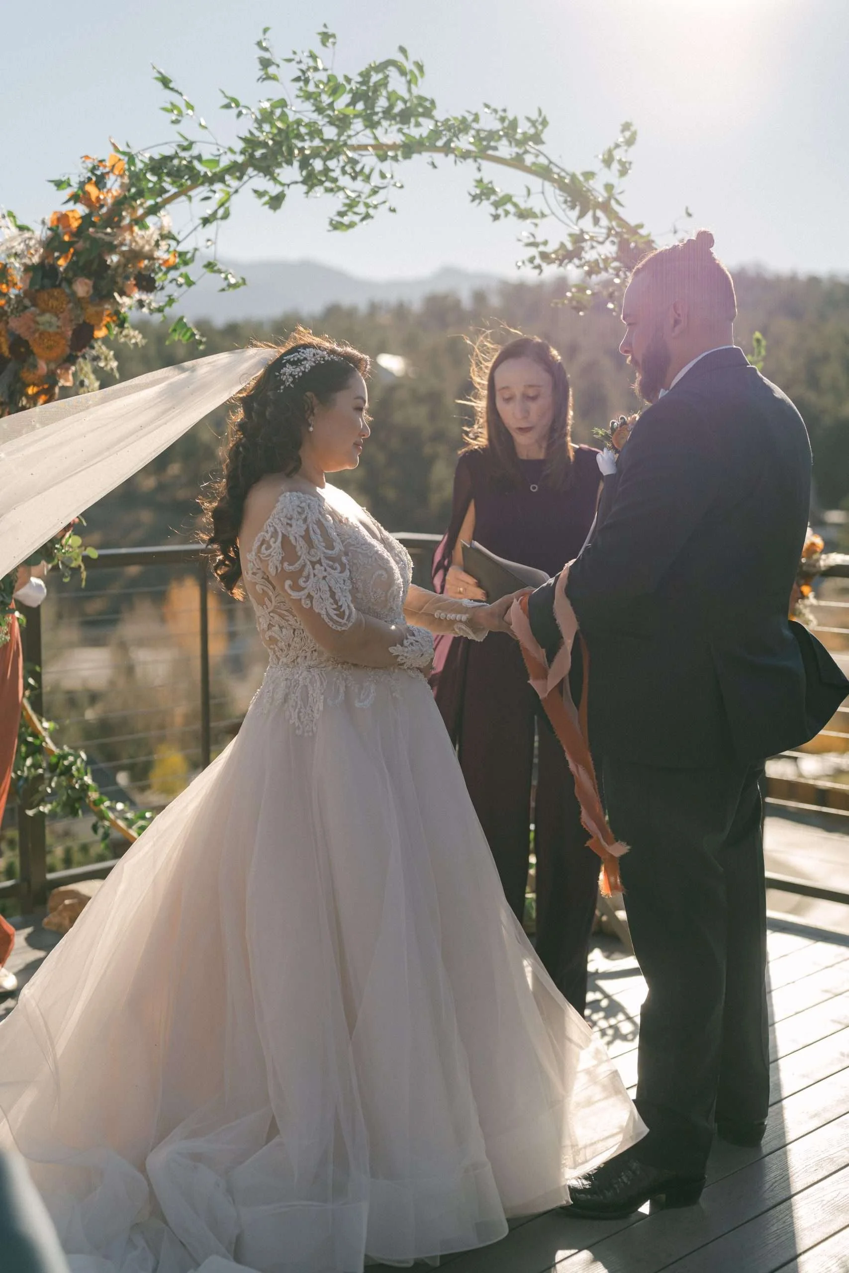 Couple exchanging vows at Colorado mountain wedding officiated by Jane Gorman