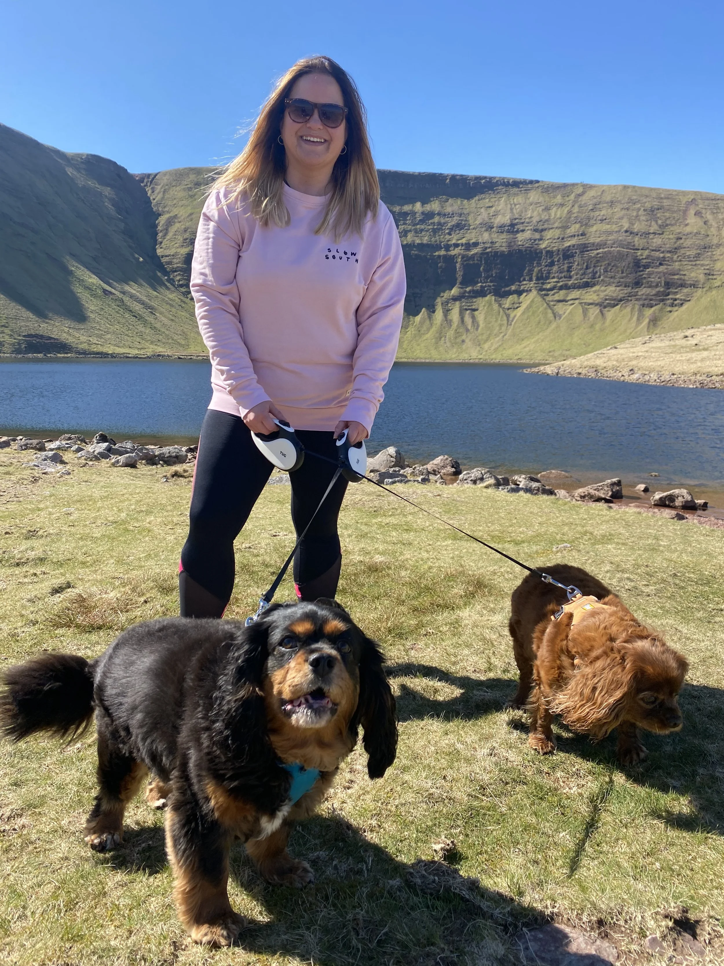 Emily Ayres Celebrates at Llyn Y Fan Fach, Bannau Brycheiniog, with her 2 cavalier king charles spaniels