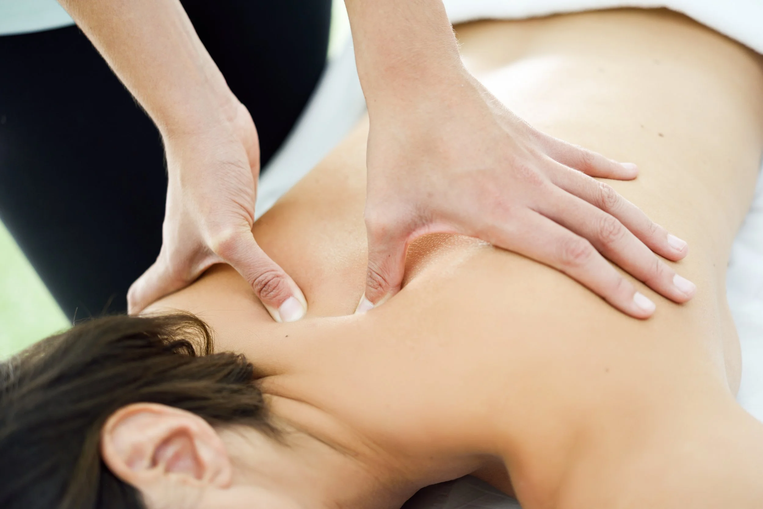 woman-receiving-back-massage-spa