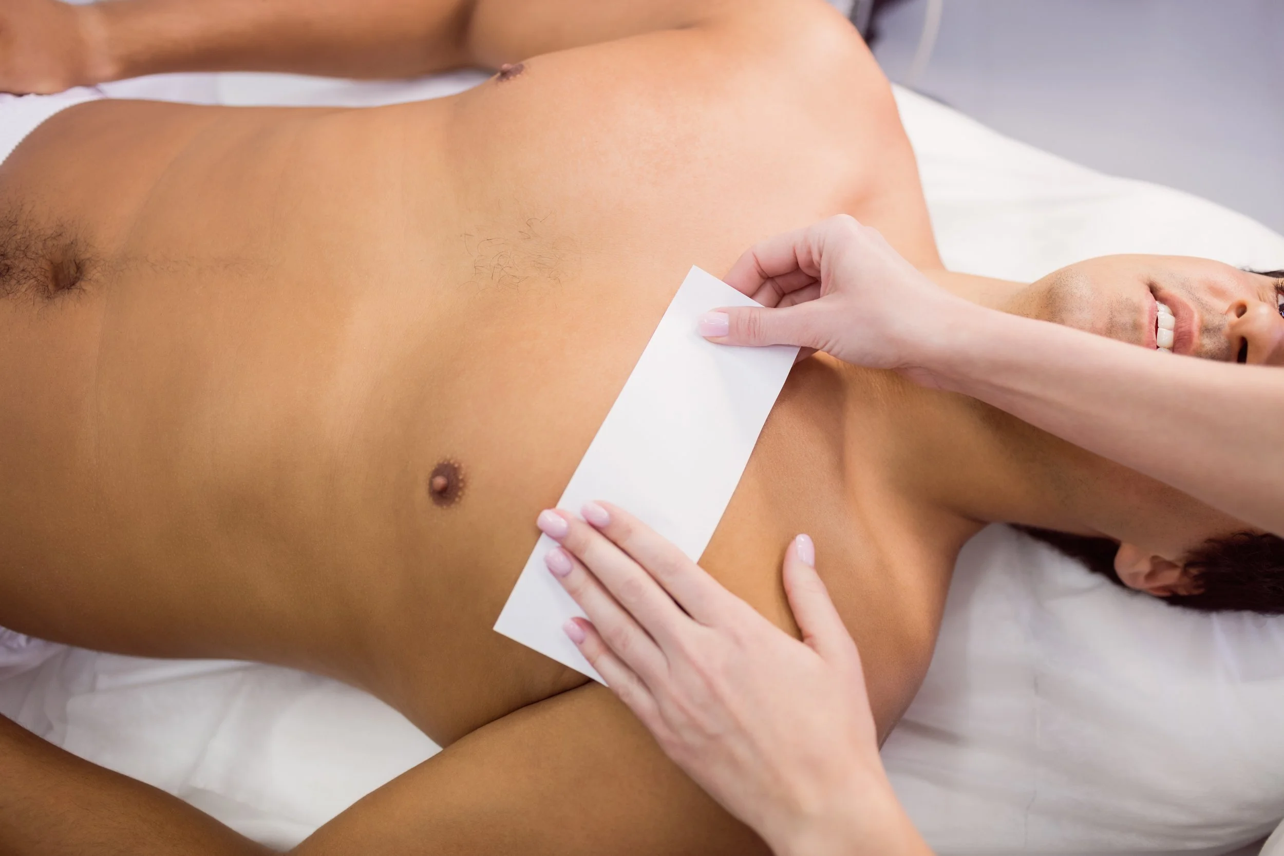 man-getting-his-chest-waxed-with-wax-strip