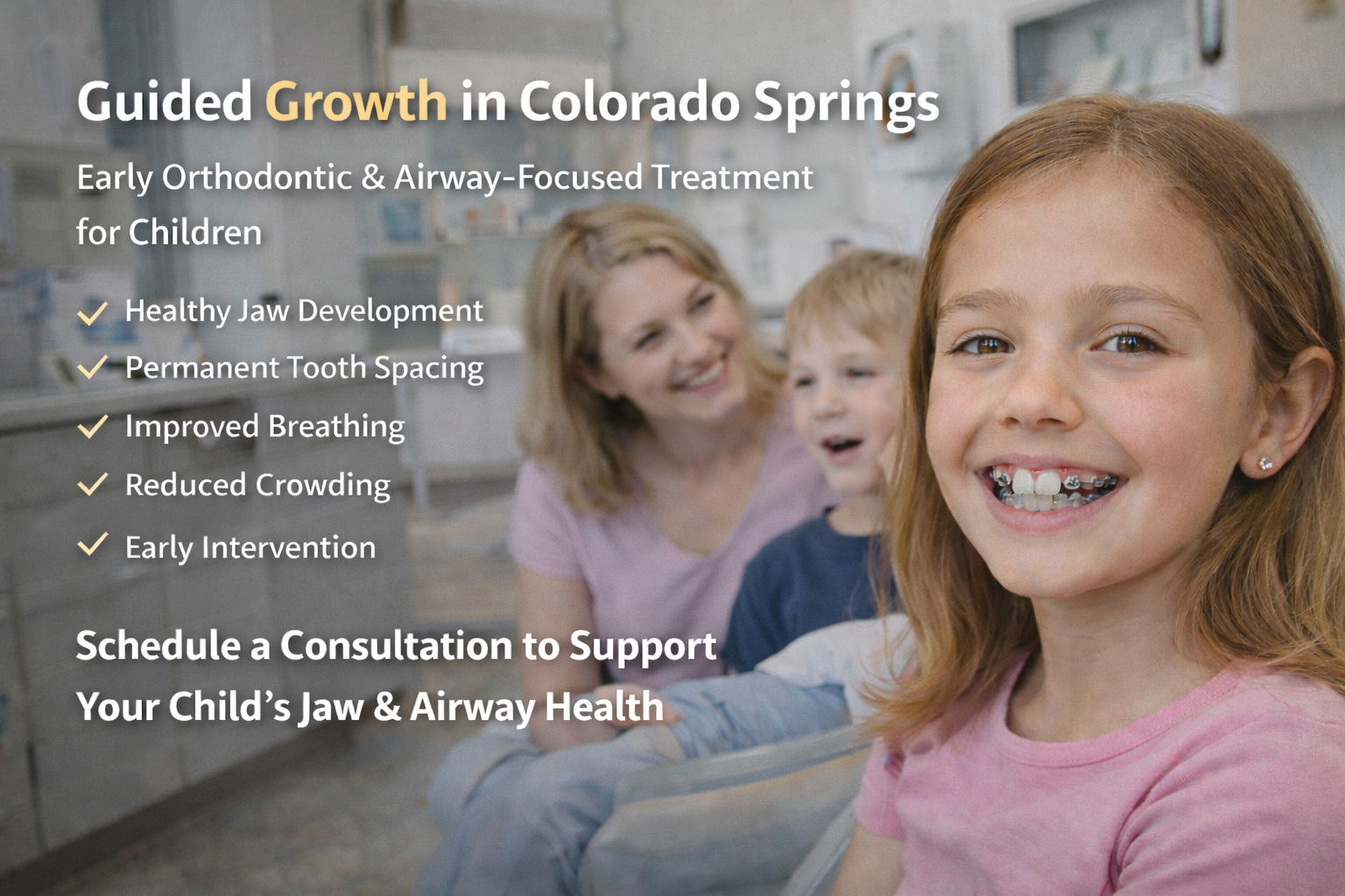 A young girl with braces smiling in a dental office with her mother and brother in the background, promoting early orthodontic treatment in Colorado Springs.