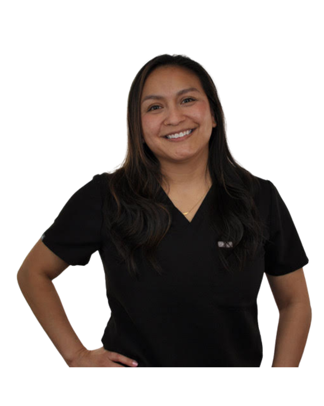 Woman in black medical scrubs smiling with hand on hip, posing for the photo.