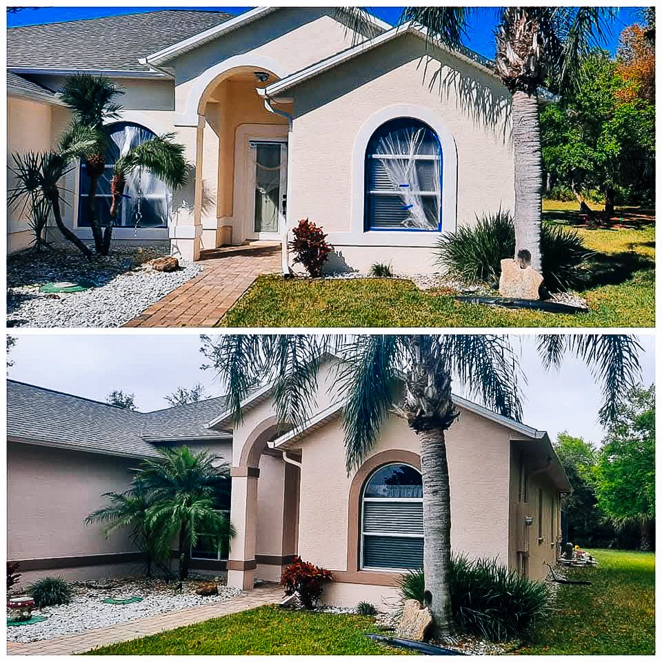 Side view of a beige house with arched windows, palm trees, and landscaped yard with rocks and plants.