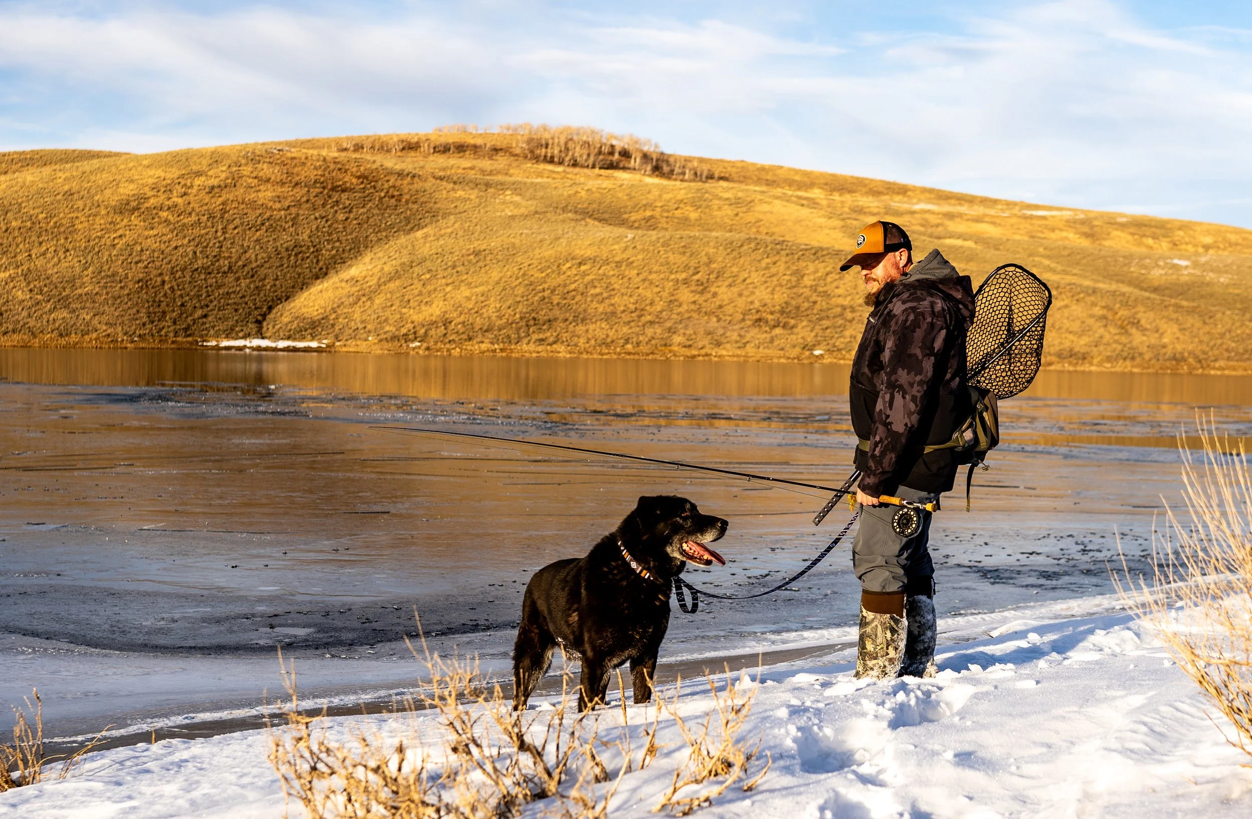 Man with dog wearing Wolfgang dog collar, by a lake