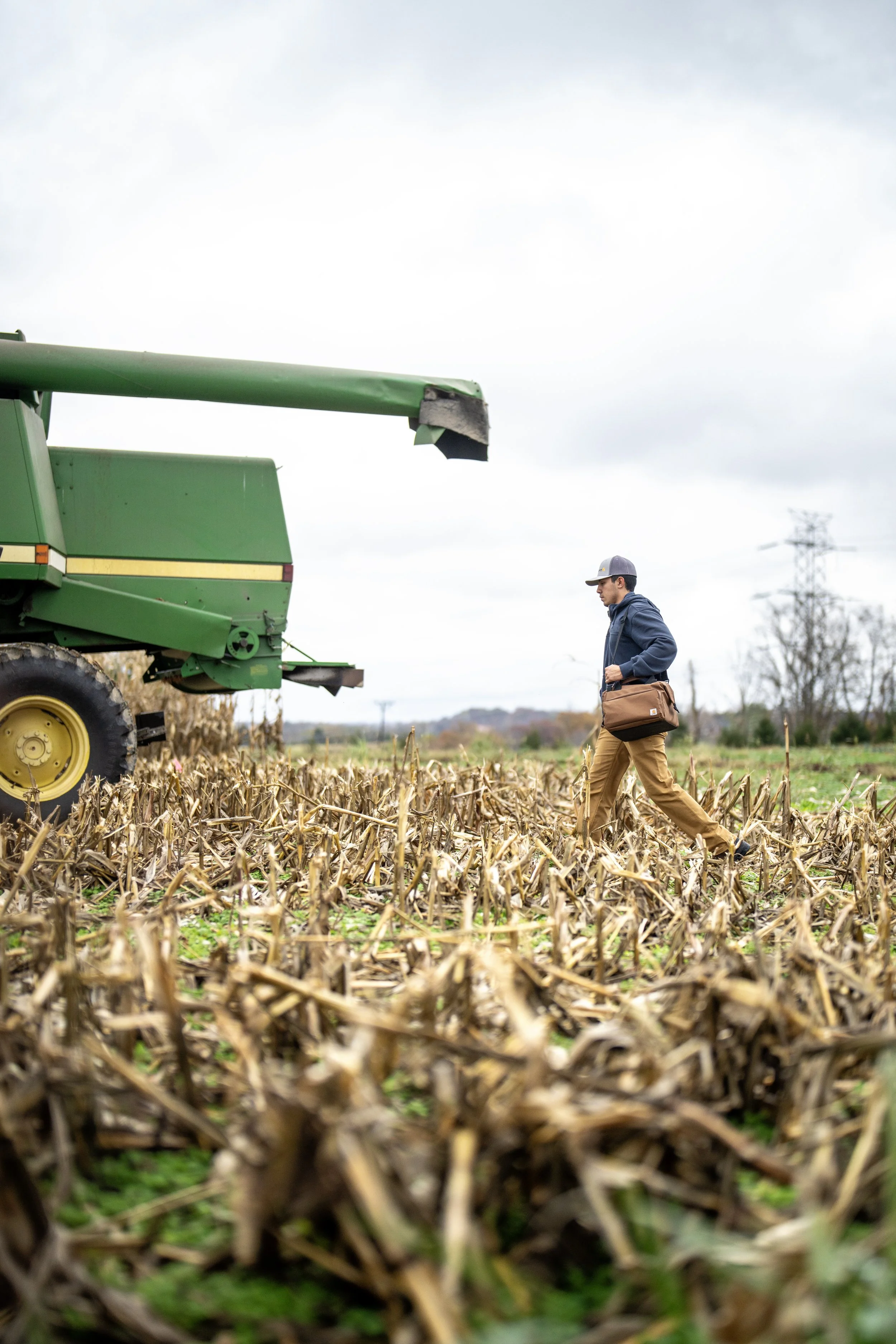 Farmer in his field with a Carhartt bag