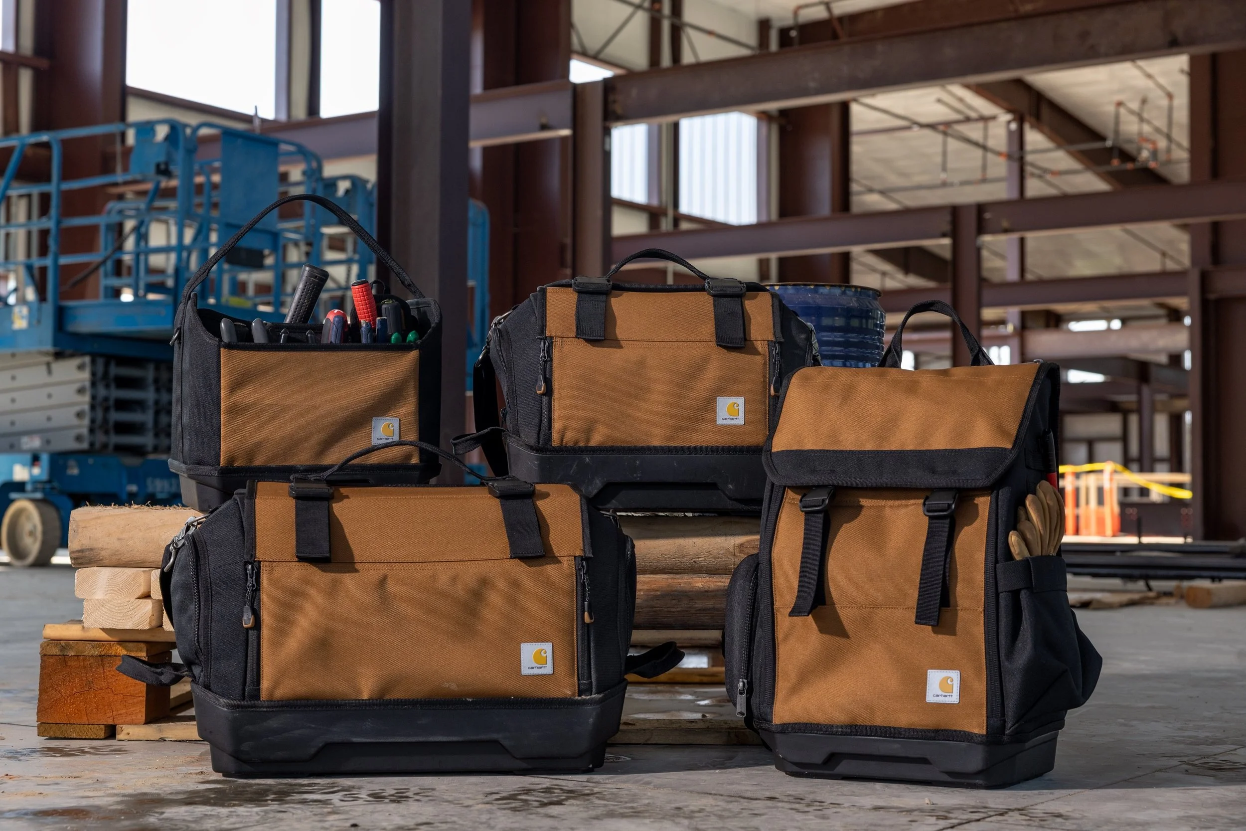 Lineup of 4 Carhartt bags on the construction site