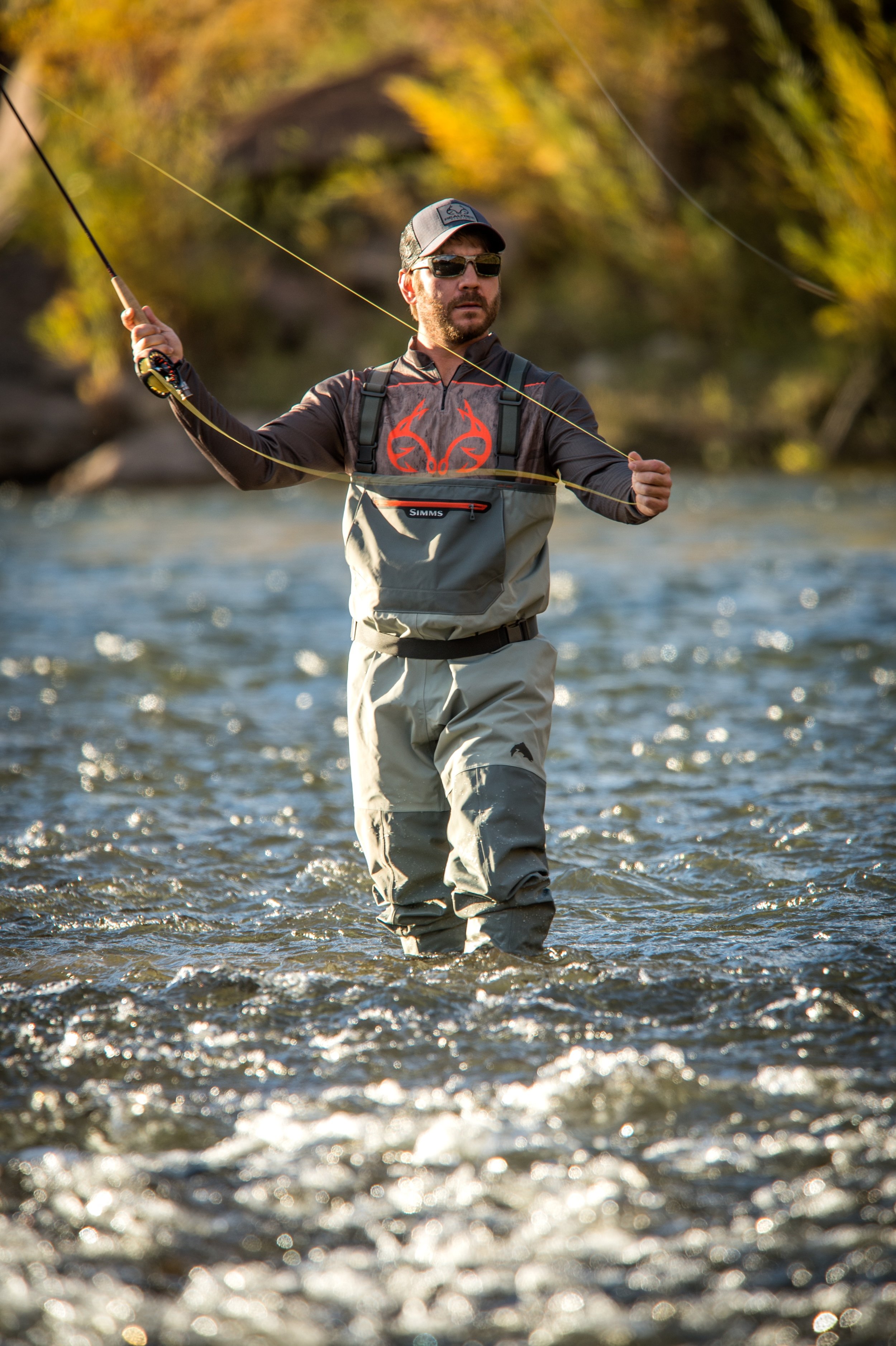 Man wearing Realtree gear while fly fishing