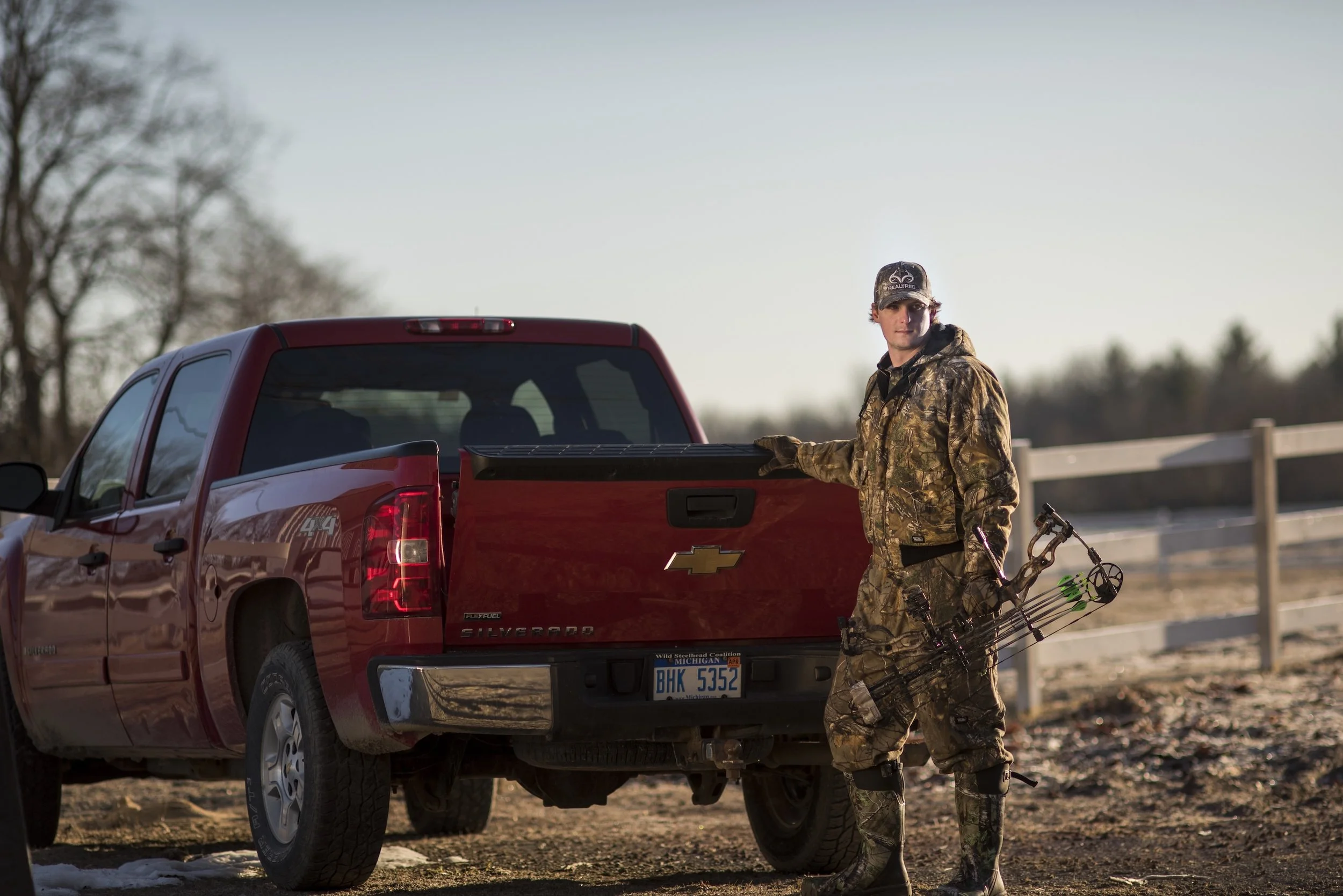 Man wearing Realtree camo by his truck