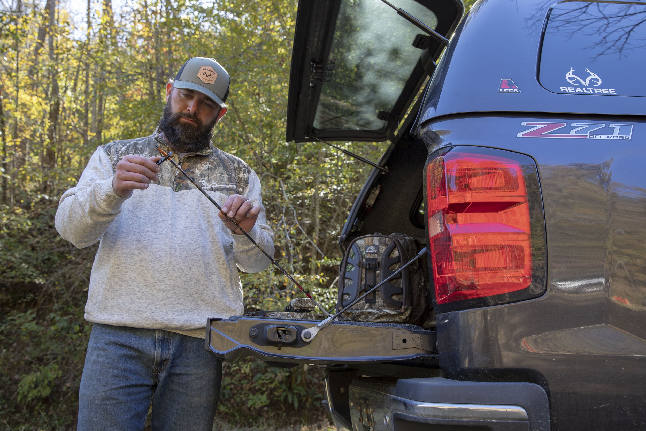 Man wearing Realtree hat by his truck