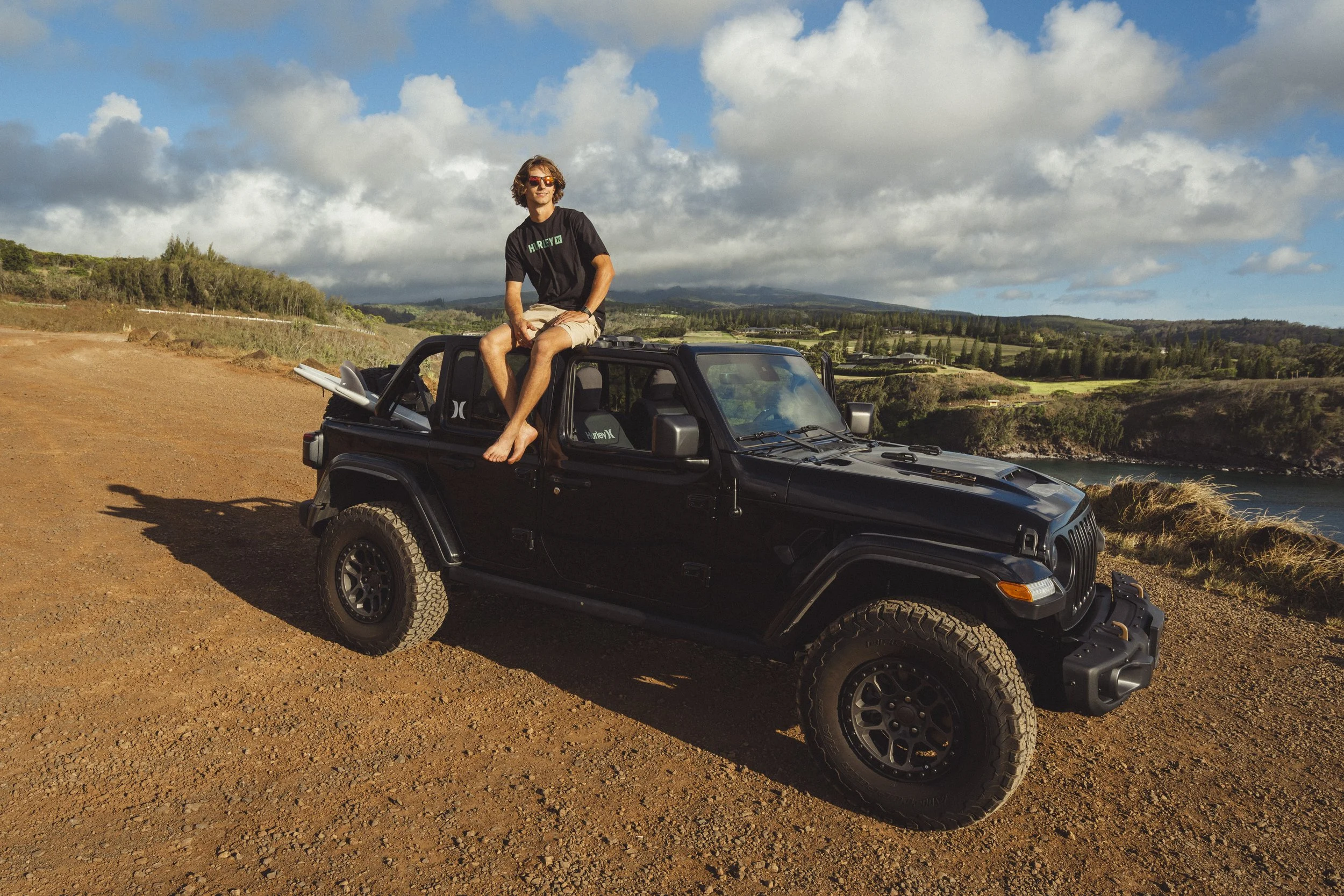 Man sitting on top of his truck
